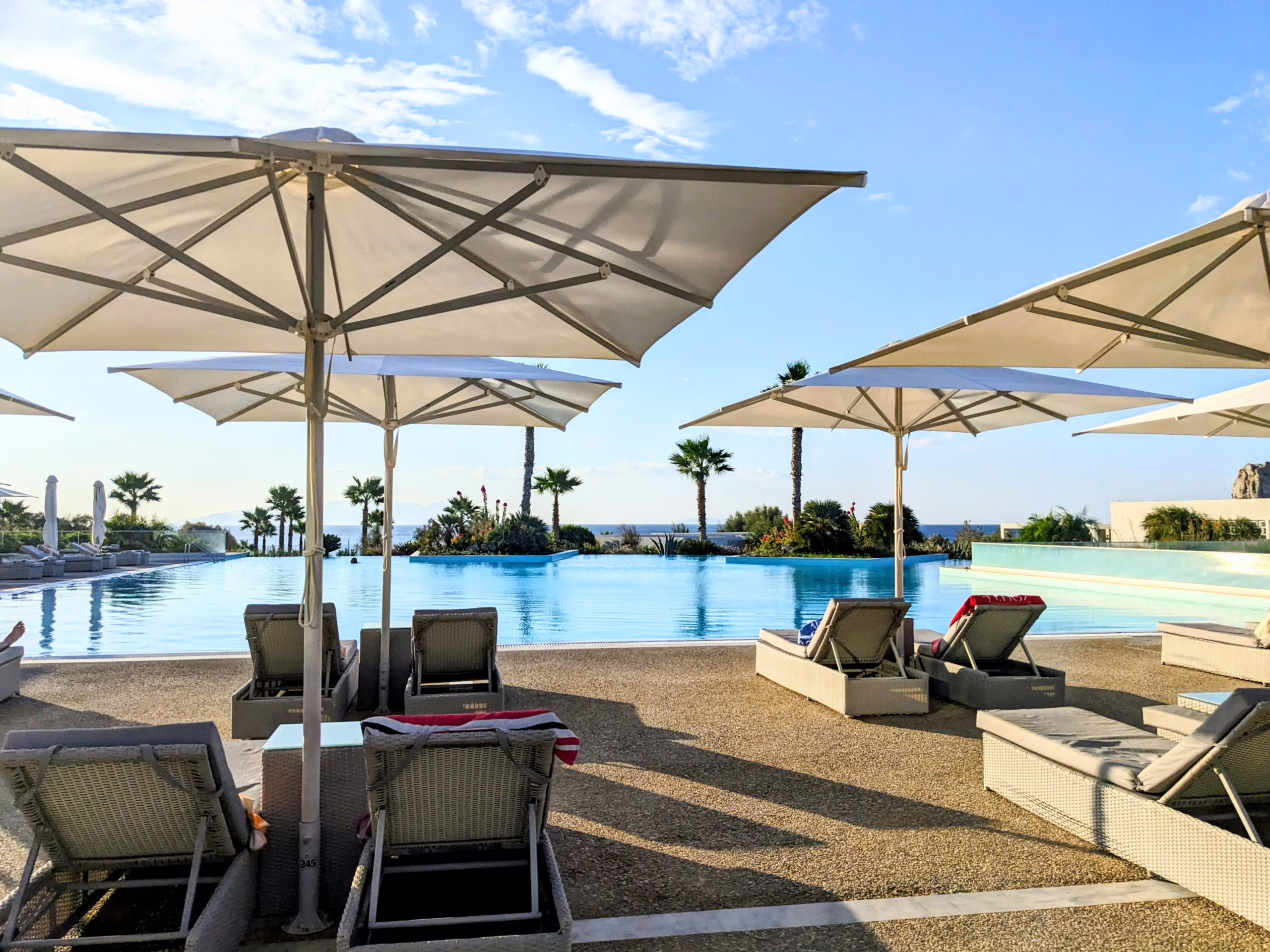 Beach Pool with umbrellas and blue skies